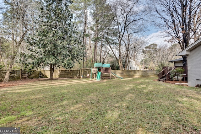 view of yard with a playground and a fenced backyard