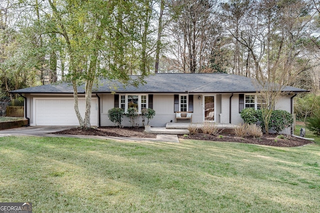 single story home with a front lawn, an attached garage, and driveway