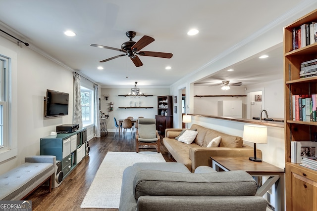 living area featuring dark wood finished floors, crown molding, recessed lighting, and ceiling fan