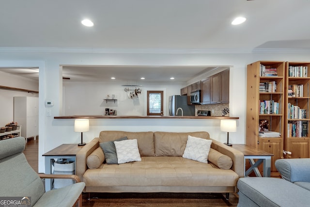 living room with recessed lighting, wood finished floors, and ornamental molding