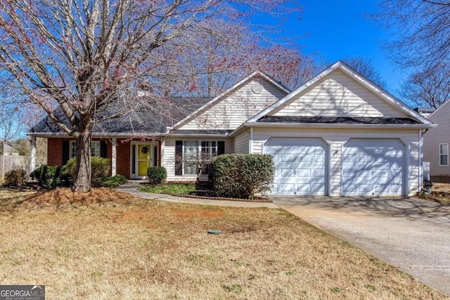 view of front facade featuring concrete driveway, a garage, and a front yard