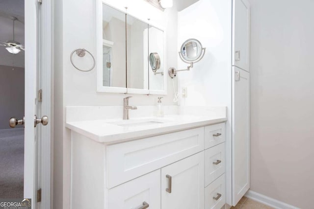 bathroom featuring vanity, a ceiling fan, and baseboards