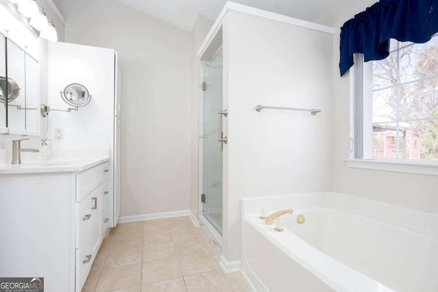 bathroom featuring a garden tub, a stall shower, tile patterned flooring, baseboards, and vanity