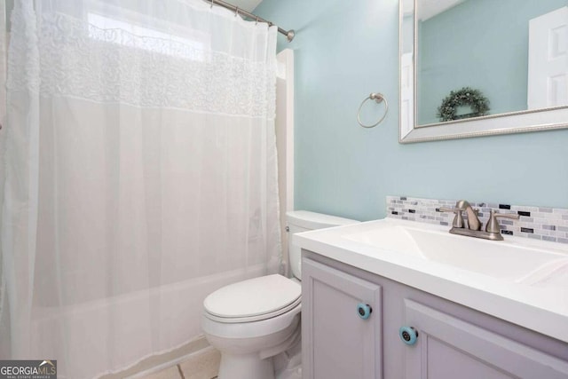 bathroom featuring vanity, toilet, shower / bath combo, and tasteful backsplash