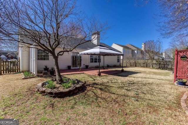 back of house with a patio area, a lawn, a gazebo, and fence