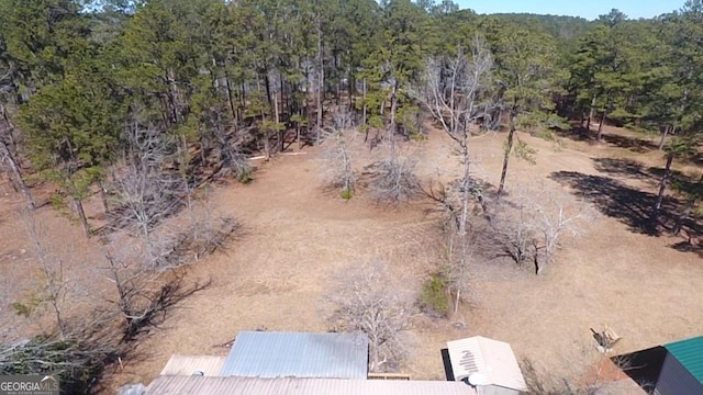 birds eye view of property with a view of trees