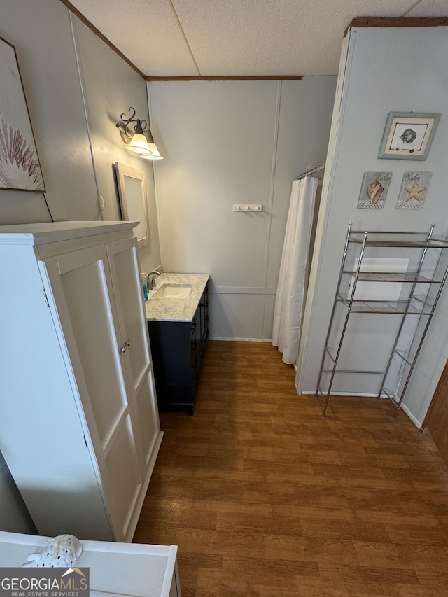 full bathroom featuring vanity and wood finished floors