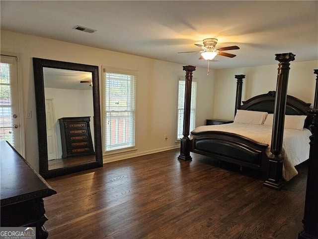 bedroom featuring ceiling fan, visible vents, baseboards, and wood finished floors