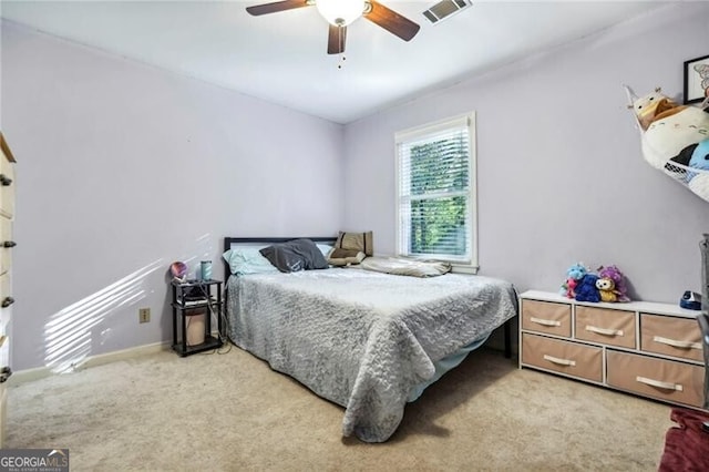 bedroom with visible vents, baseboards, light colored carpet, and a ceiling fan