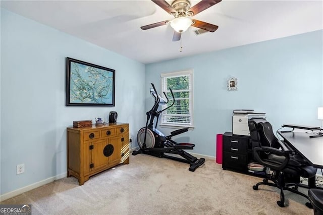 carpeted home office featuring visible vents, baseboards, and ceiling fan