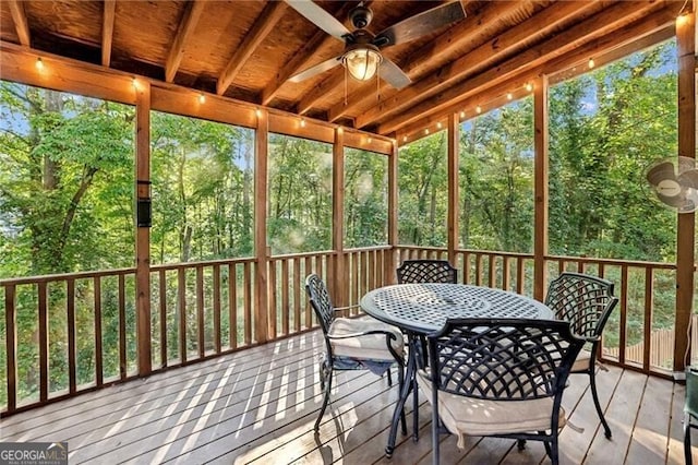 sunroom / solarium with a ceiling fan