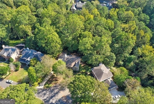 drone / aerial view featuring a wooded view