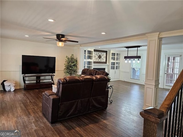 living area with dark wood-style flooring, a ceiling fan, and decorative columns