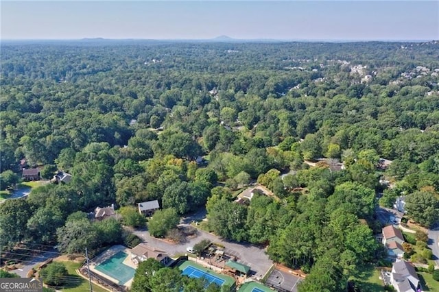 birds eye view of property with a wooded view