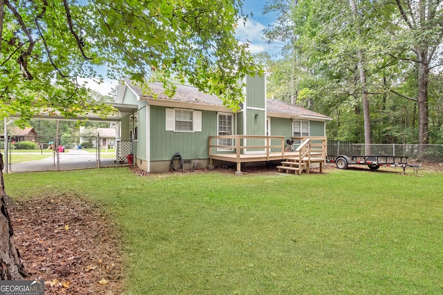 back of property with a carport, a lawn, fence, and crawl space