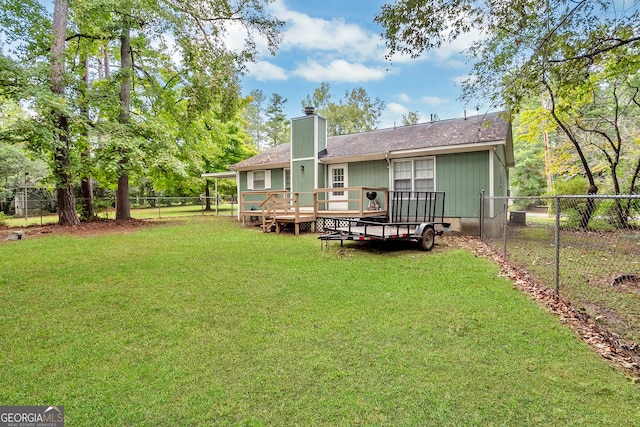 rear view of property with a lawn, a chimney, a fenced backyard, a deck, and crawl space