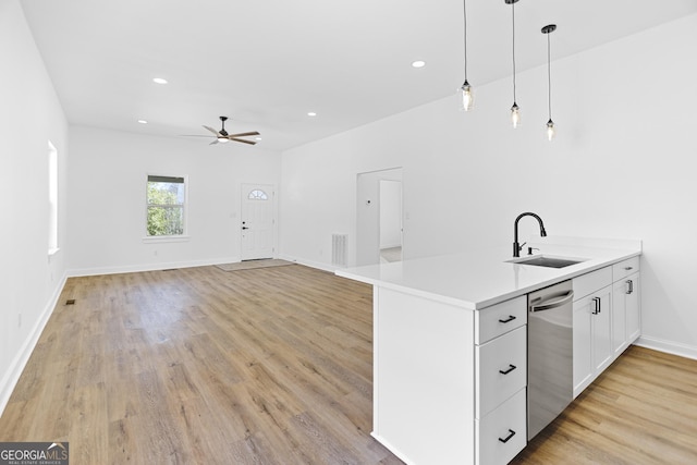 kitchen with visible vents, dishwasher, hanging light fixtures, a ceiling fan, and a sink