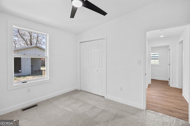 unfurnished bedroom with visible vents, baseboards, carpet floors, a closet, and a ceiling fan