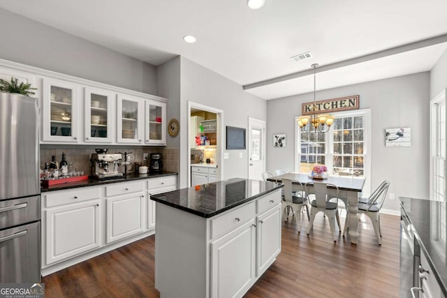 kitchen featuring visible vents, an inviting chandelier, dark wood-style floors, and freestanding refrigerator