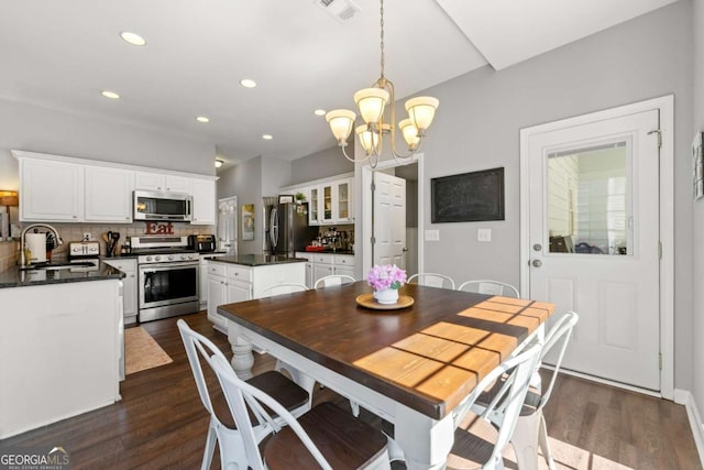 dining room with recessed lighting, visible vents, an inviting chandelier, and dark wood finished floors