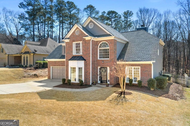 view of front facade featuring brick siding, an attached garage, concrete driveway, and fence