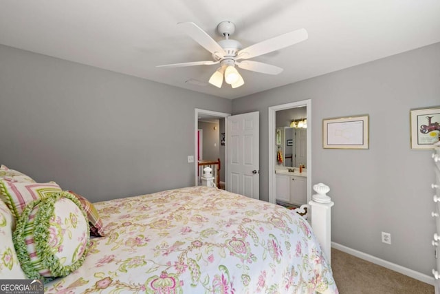 carpeted bedroom with baseboards, ensuite bath, and ceiling fan