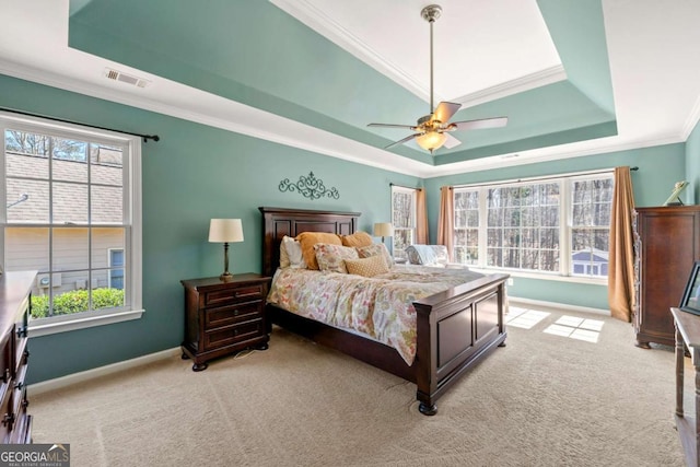 bedroom with visible vents, a raised ceiling, baseboards, and crown molding