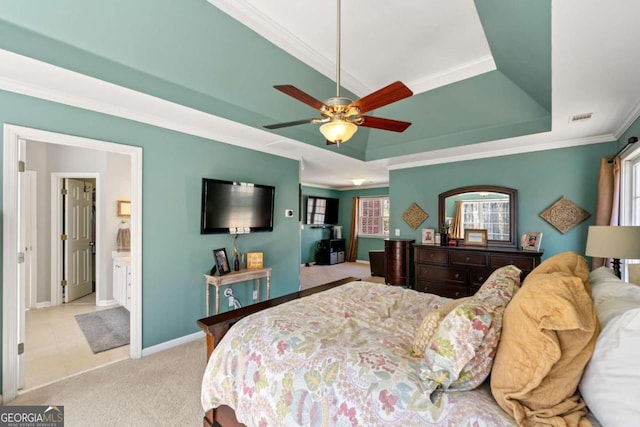 bedroom featuring visible vents, crown molding, baseboards, light carpet, and a raised ceiling