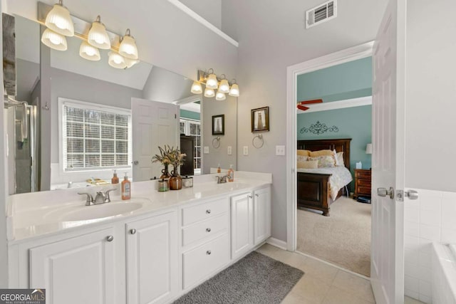 full bathroom featuring a sink, visible vents, a bath, and double vanity