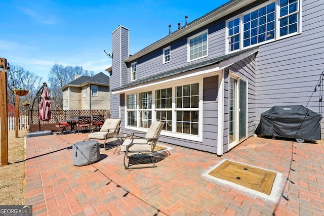 view of patio / terrace with grilling area, outdoor dining space, and fence