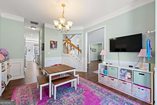 dining room featuring visible vents, dark wood-type flooring, a notable chandelier, stairway, and crown molding