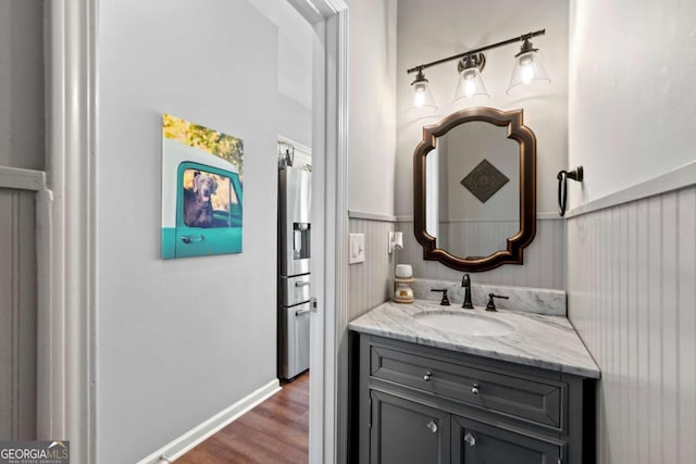 bathroom with wood finished floors and vanity