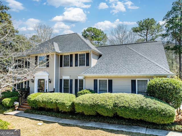 colonial home with a shingled roof