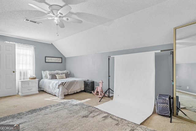 carpeted bedroom with visible vents, baseboards, vaulted ceiling, a textured ceiling, and a ceiling fan