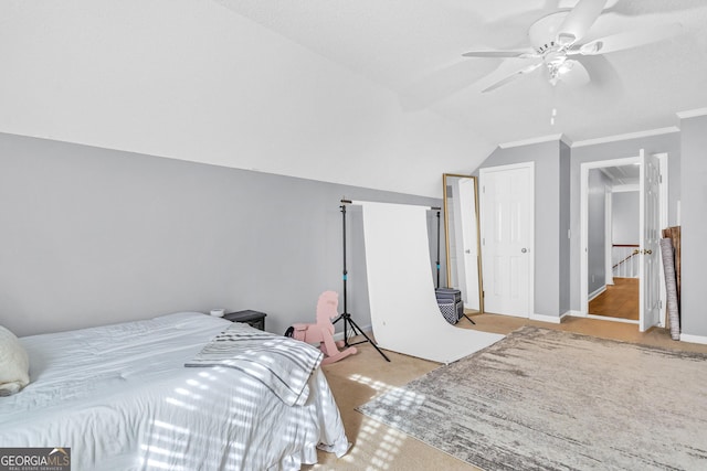 bedroom featuring a ceiling fan, baseboards, carpet floors, ornamental molding, and vaulted ceiling