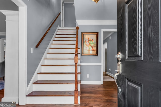 entrance foyer featuring ornamental molding, stairs, baseboards, and wood finished floors