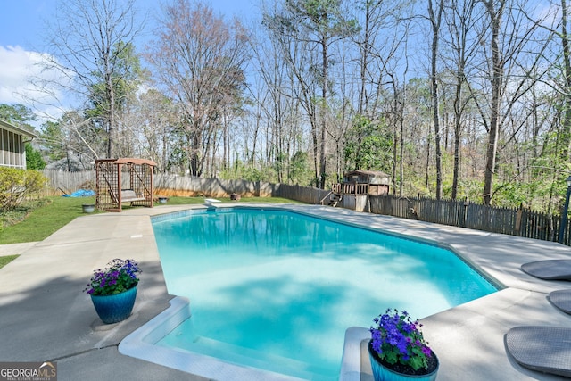 view of pool featuring a patio, a diving board, a fenced backyard, and a fenced in pool