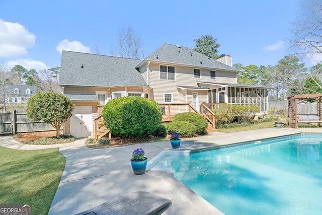 view of pool with stairway, fence, a fenced in pool, a wooden deck, and a sunroom