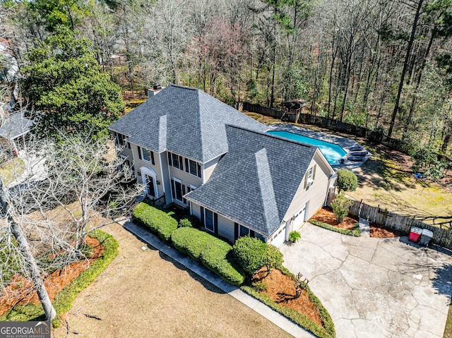 drone / aerial view featuring a wooded view