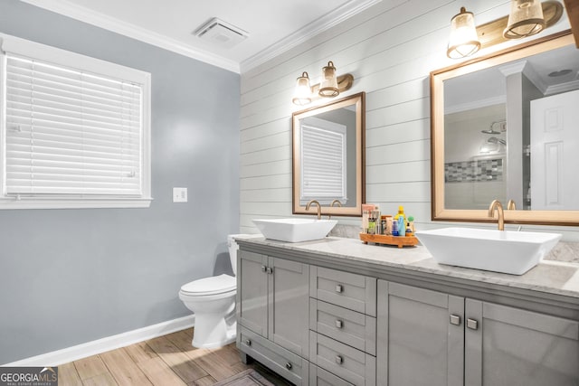 full bath with a sink, visible vents, wood finished floors, and ornamental molding