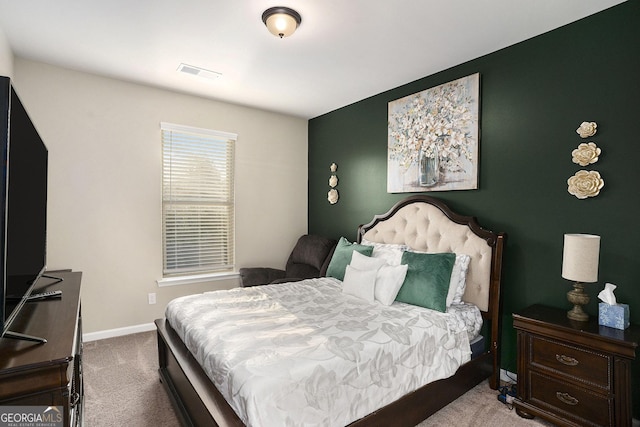 bedroom featuring baseboards, visible vents, and carpet floors