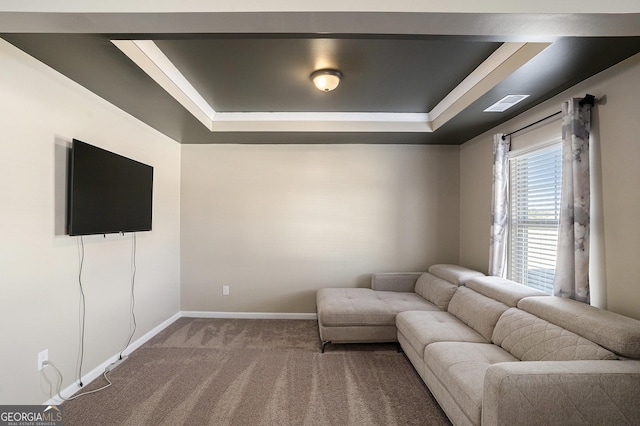 living area featuring baseboards, a raised ceiling, visible vents, and dark carpet