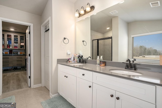 full bath with a sink, visible vents, and a stall shower