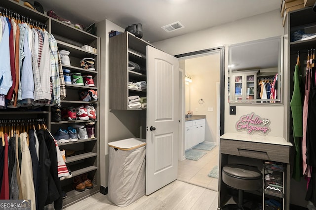 walk in closet with visible vents and light wood-type flooring