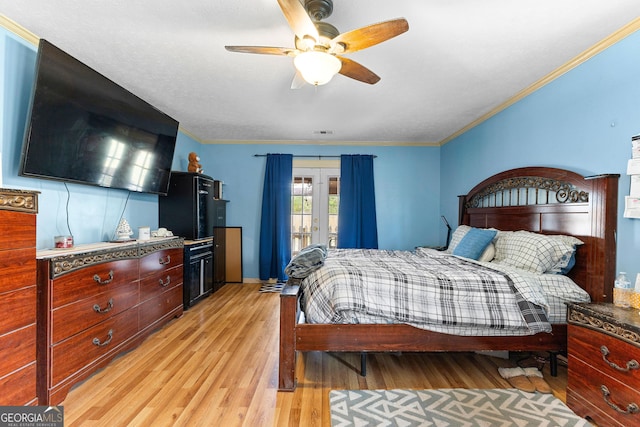 bedroom featuring visible vents, french doors, light wood-style floors, and ornamental molding