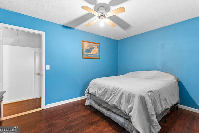 bedroom with ceiling fan, baseboards, a textured ceiling, and wood finished floors