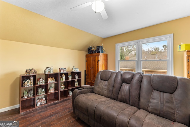 living room featuring dark wood finished floors, vaulted ceiling, a ceiling fan, and baseboards