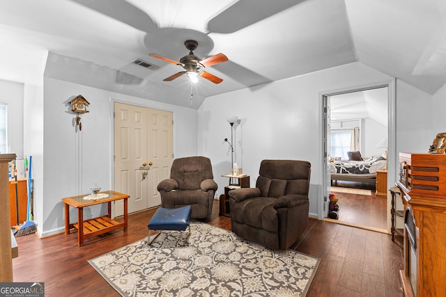 sitting room with visible vents, baseboards, dark wood finished floors, vaulted ceiling, and a ceiling fan