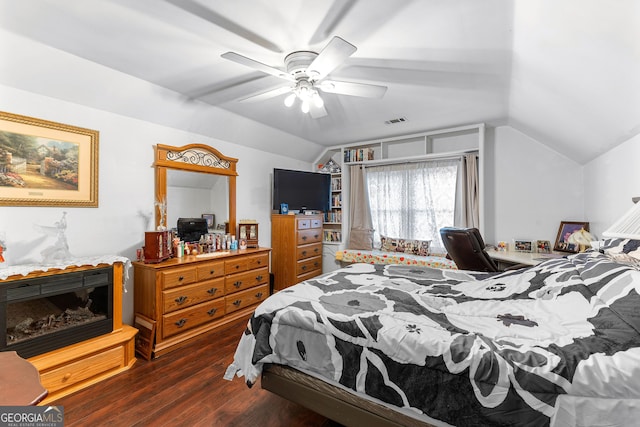 bedroom with a ceiling fan, lofted ceiling, wood finished floors, and visible vents