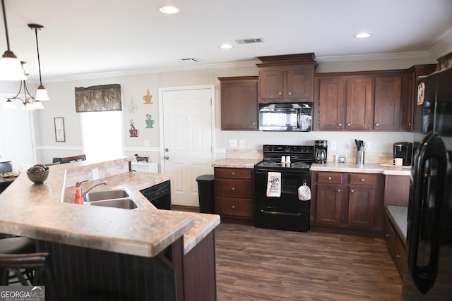 kitchen with a sink, black appliances, light countertops, dark wood-type flooring, and crown molding